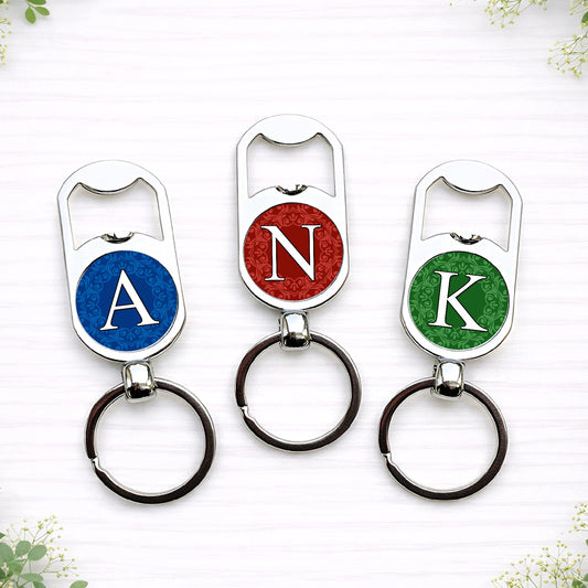 Personalised initial bottle opener keyrings in custom wedding colours featuring monogram letters on circular designs.