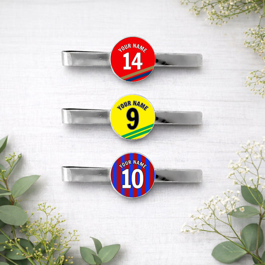 Personalised football team tie clips with custom name, number and colours on white background
