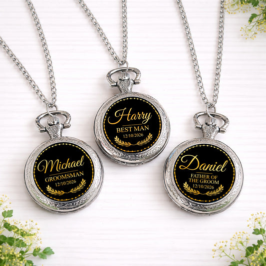 Three personalised black and gold wedding role pocket watches with names and dates displayed on silver chains.