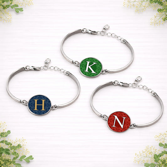 Personalised wedding colour initial bracelets in custom red, green and navy designs with silver adjustable bands.