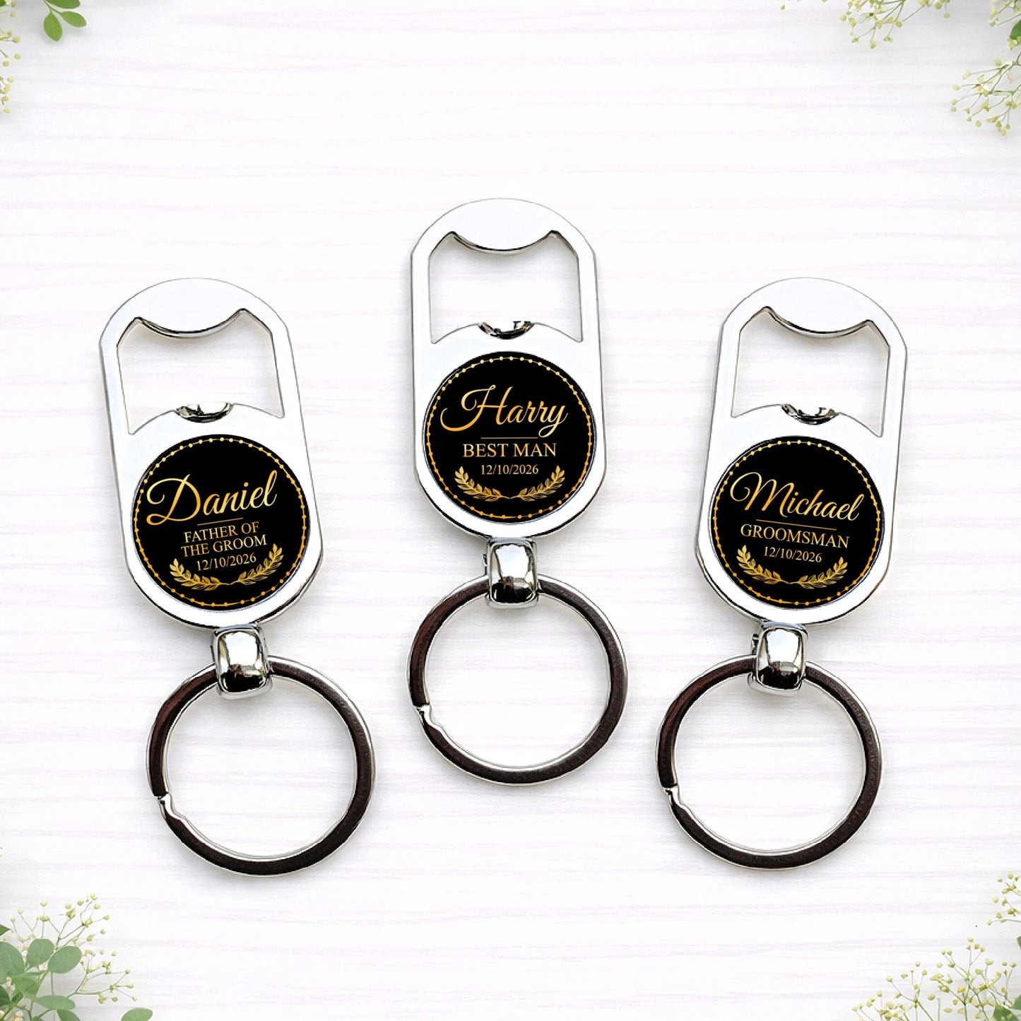 Personalised black and gold groomsman bottle opener keyrings with custom names, wedding roles and date in elegant circular seal design.
