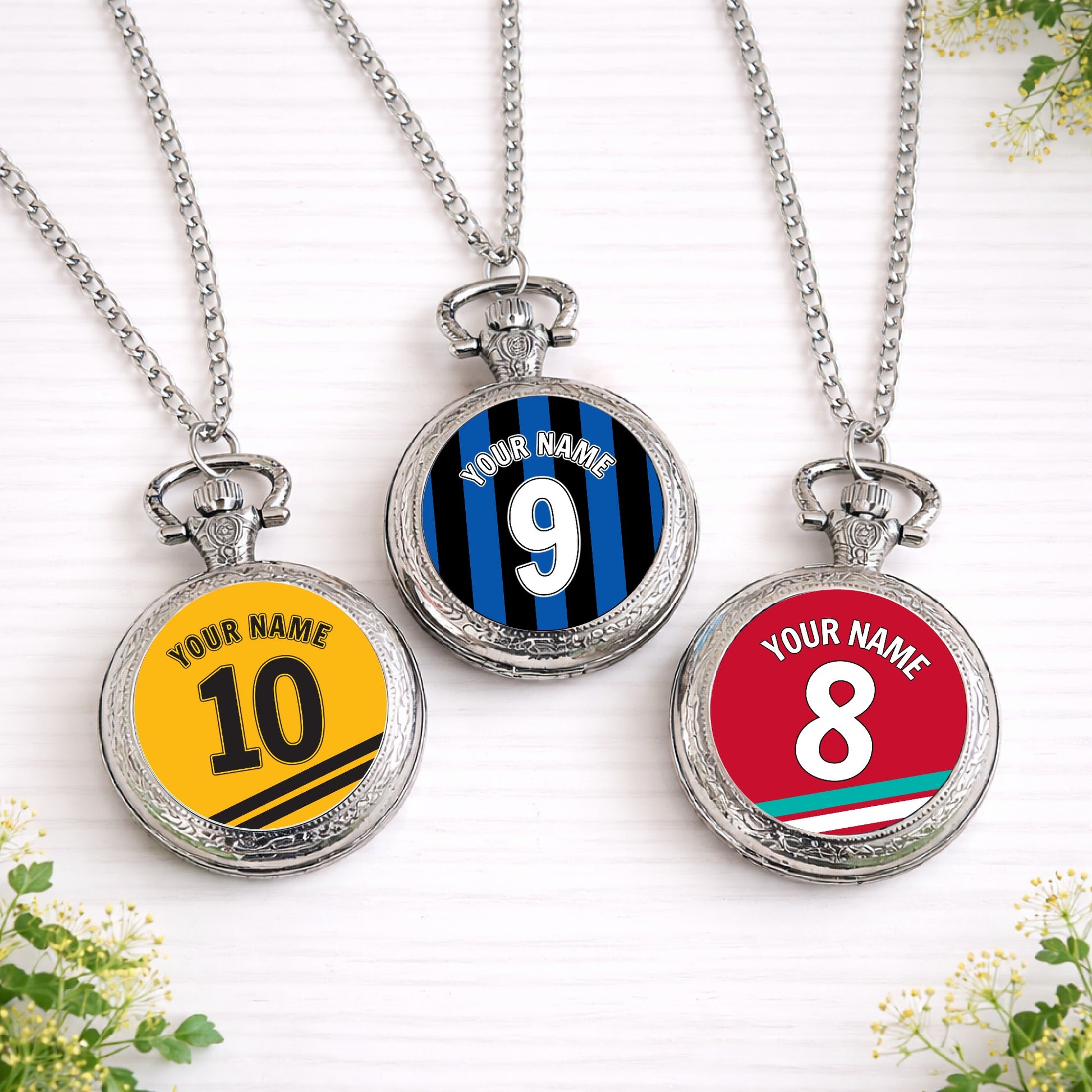 Personalised silver pocket watches featuring custom football shirt designs in team colours with name and number, created as unique groomsmen gifts.