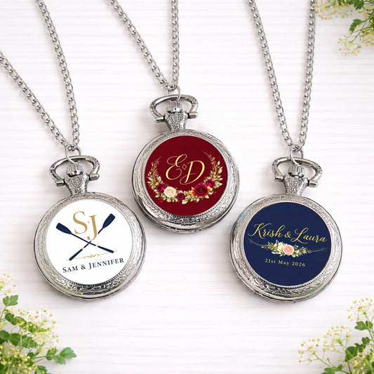 Silver personalised pocket watches featuring custom wedding logos and monograms in floral and crest designs, displayed with chains.