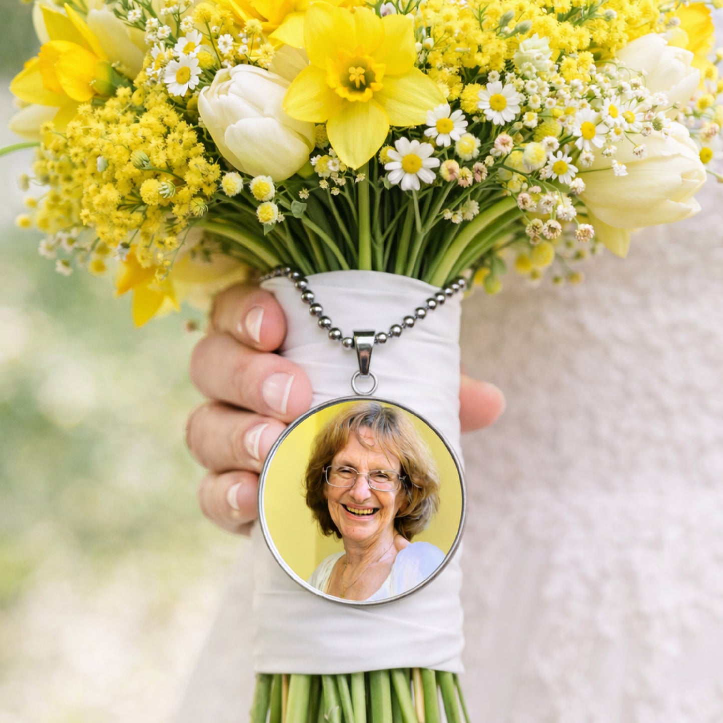 Yellow bridal bouquet with custom photo remembrance charm attached to bouquet handle.